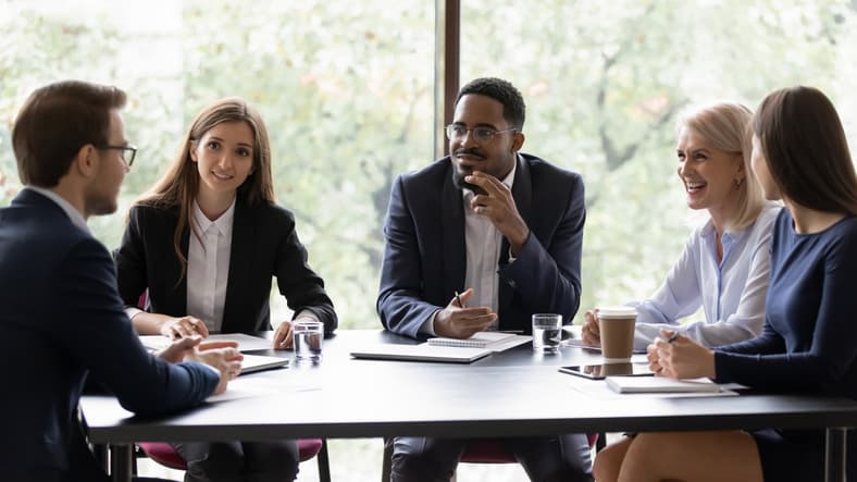 A group of diverse professionals discussing A group of diverse professionals discussing